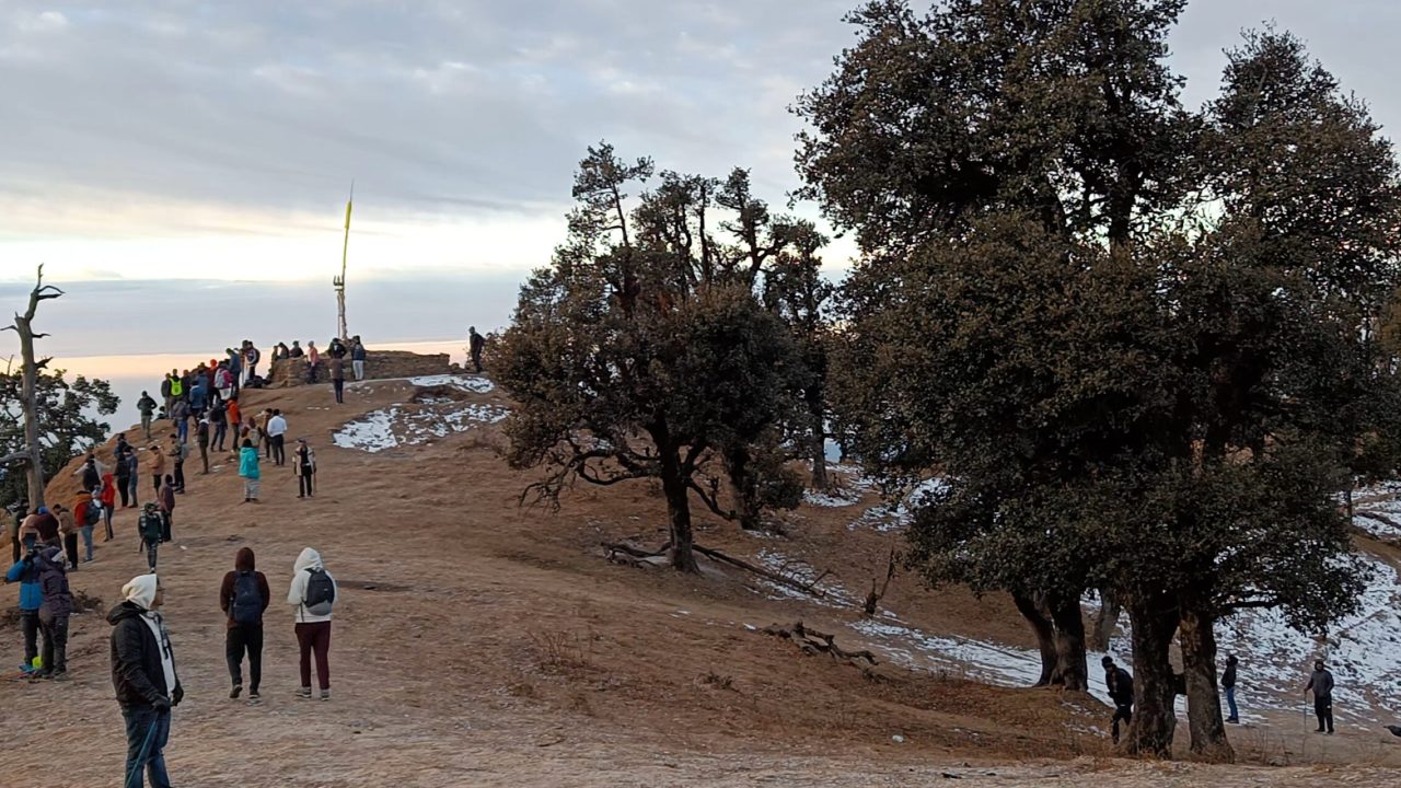 people are enjoying the view at Nag Tibba Summit